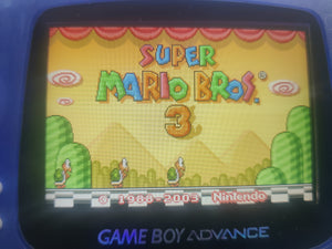 Game Boy Advance displaying the title screen of 'Super Mario Bros. 3' with a blue border.
